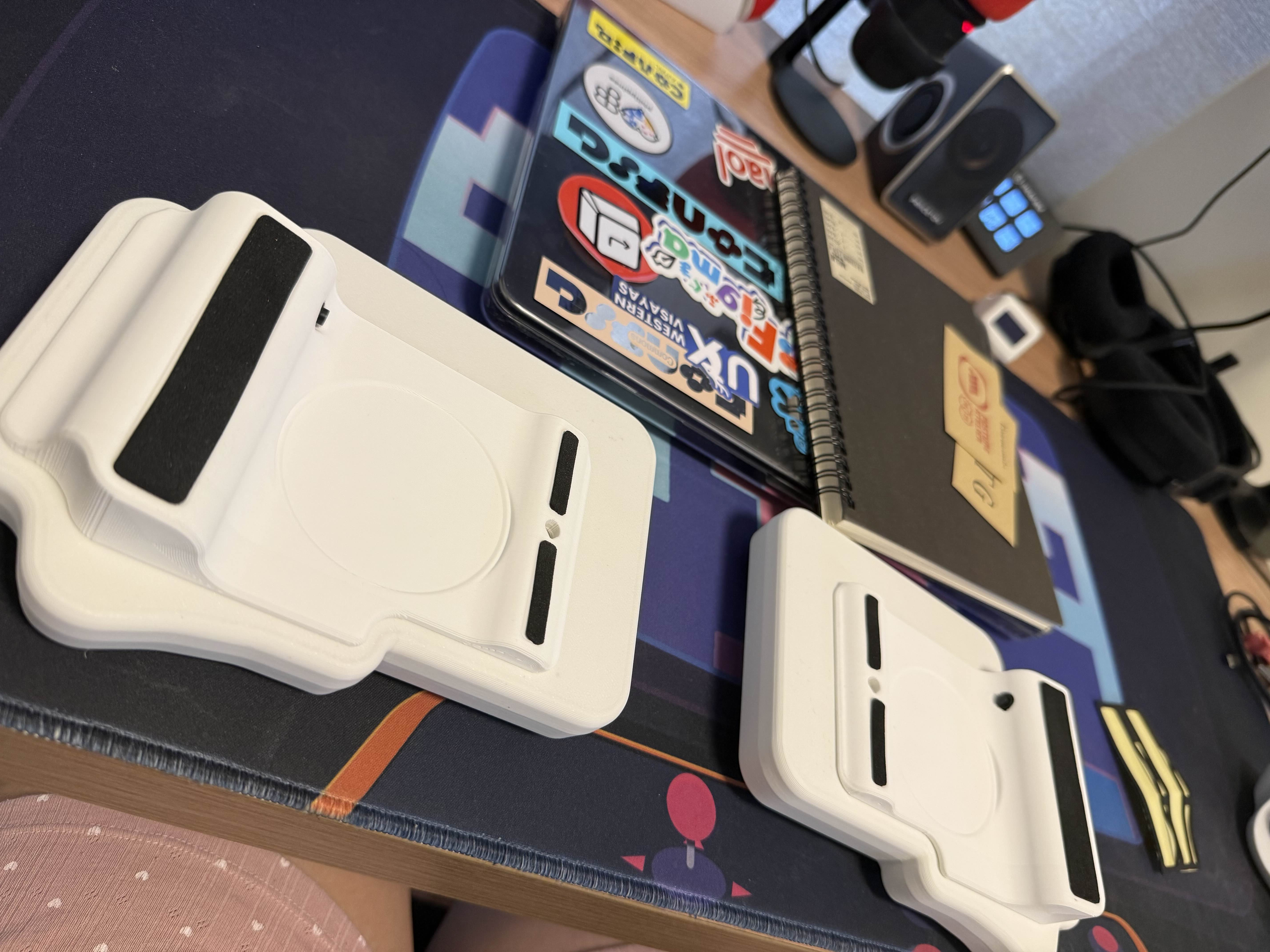 Two parts of Chi’s Baseform keyboard parts flipped to show its white 3d-printed base with black rubber pads stuck to some spots that show that something is supposed to go there. Also on her desk is her work Macbook with a bunch of stickers stuck on the clear casing, a Muji sketch notebook, and her Tambayan 404 deskmat. The used rubber sheet is also shown on the rightmost side, with the marked parts removed already.