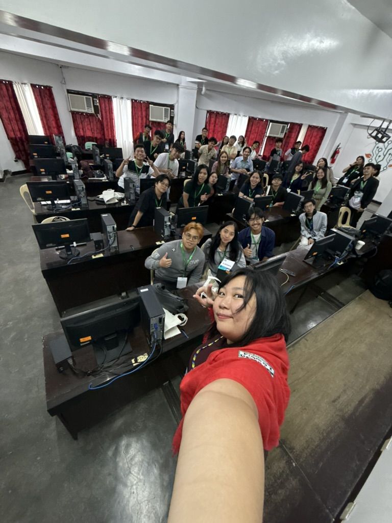 The first out of 3 workshop legs, this one is for the Davao leg! Chi doing a wide angle selfie with the attendees of her workshop at UXPH Mini 2025: Davao in a computer lab classroom.